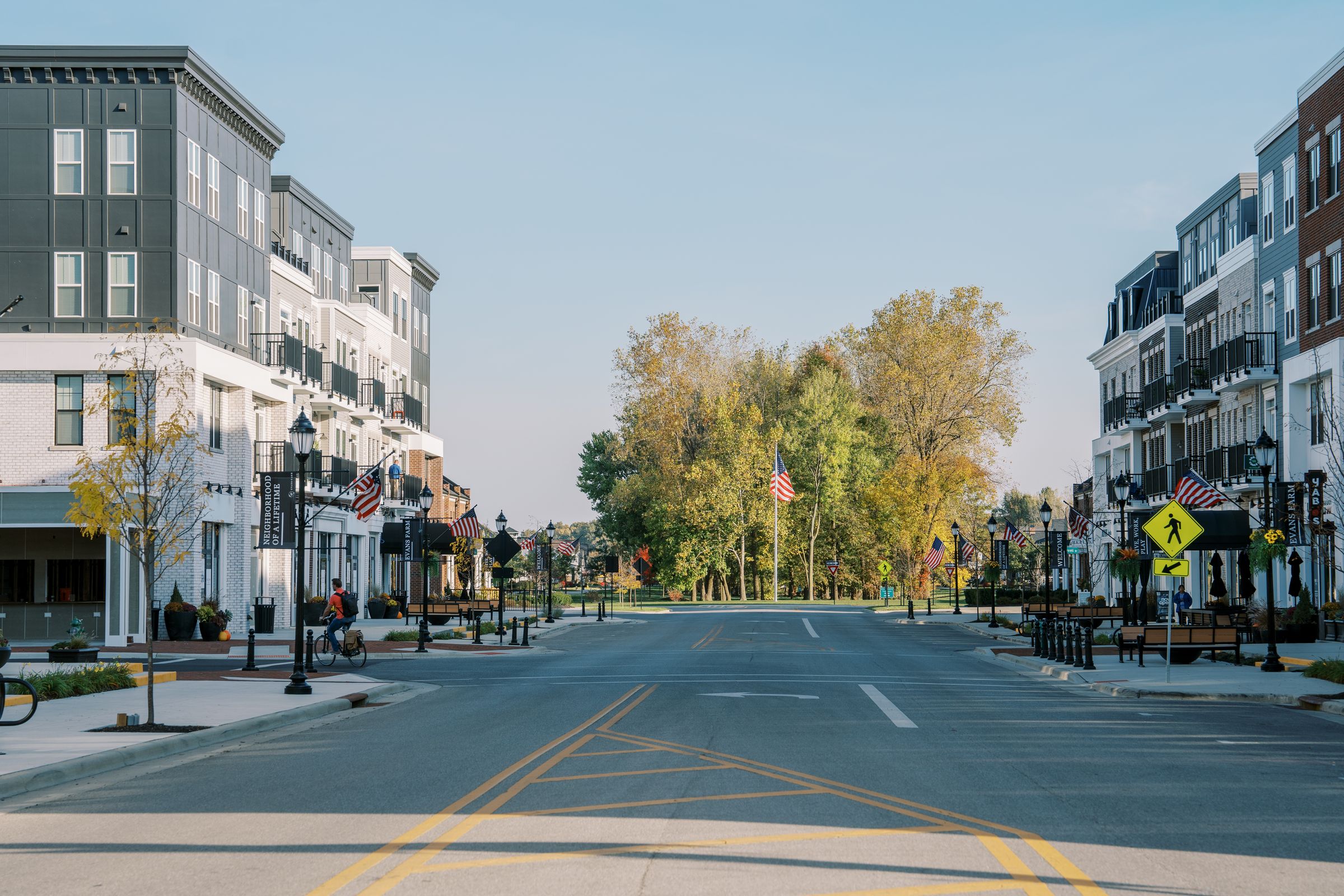 Flag-lined main street in Evans Farm leading toward Central Park